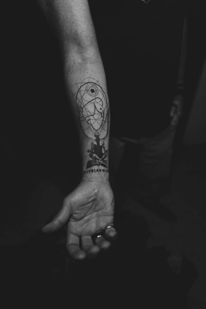 Tattooed arm of Not Your Average Joe men's coach