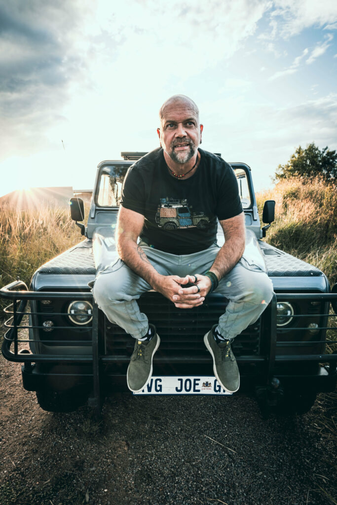 Not your average joe men's coach sitting on his landrover